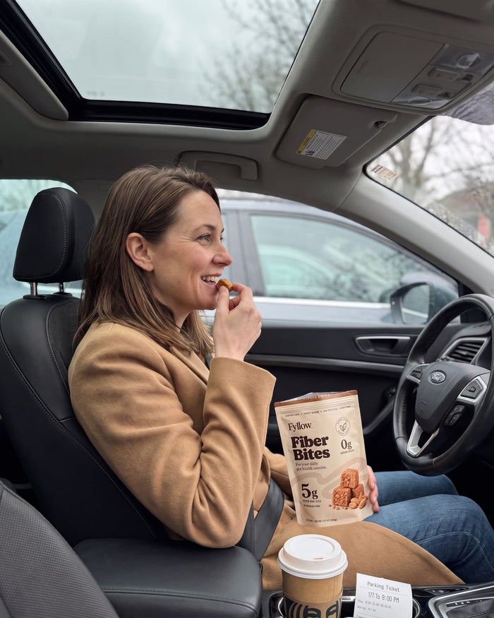Woman eating a Fiber Bite in her car