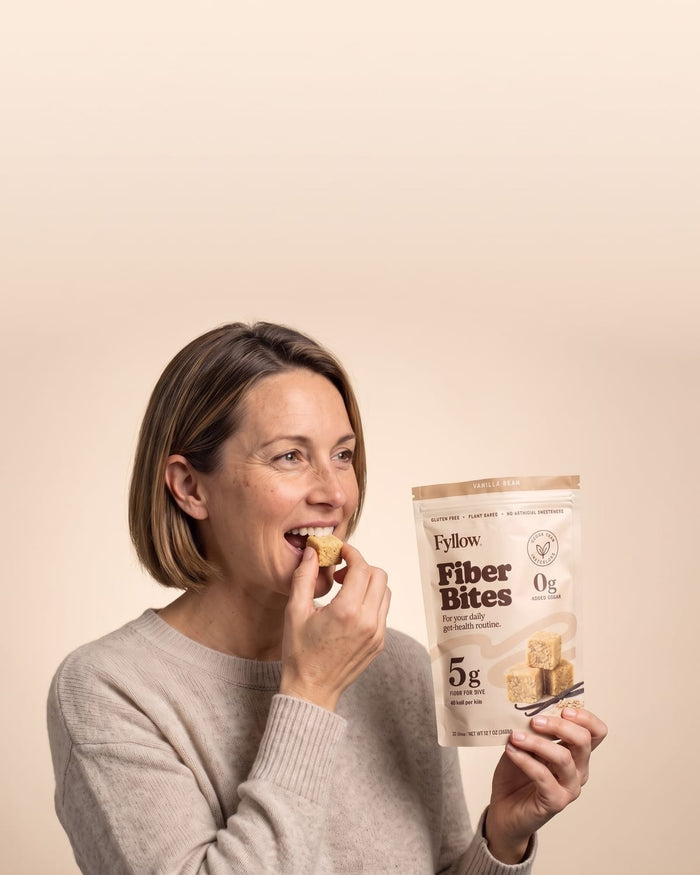 Woman taking a bite of a Vanilla Bean Fiber Bite