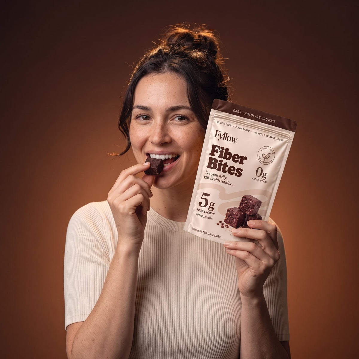 Woman enjoying a Dark Chocolate Brownie Fiber Bite