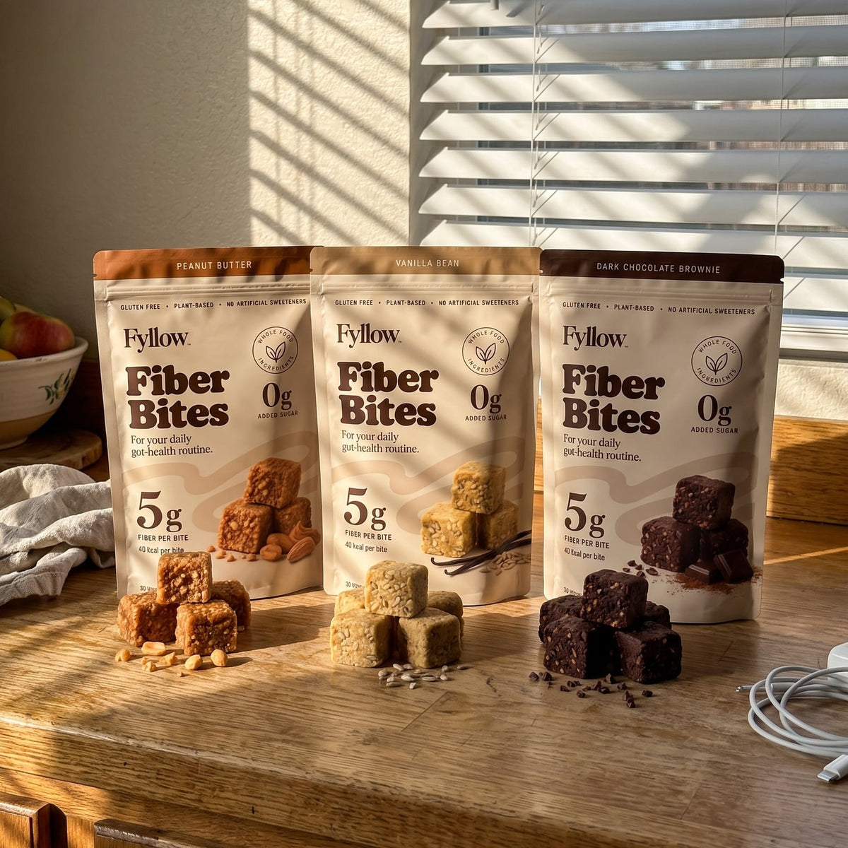 Fyllow Fiber Bites in Peanut Butter, Vanilla Bean and Dark Chocolate Brownie on a sunny kitchen counter.