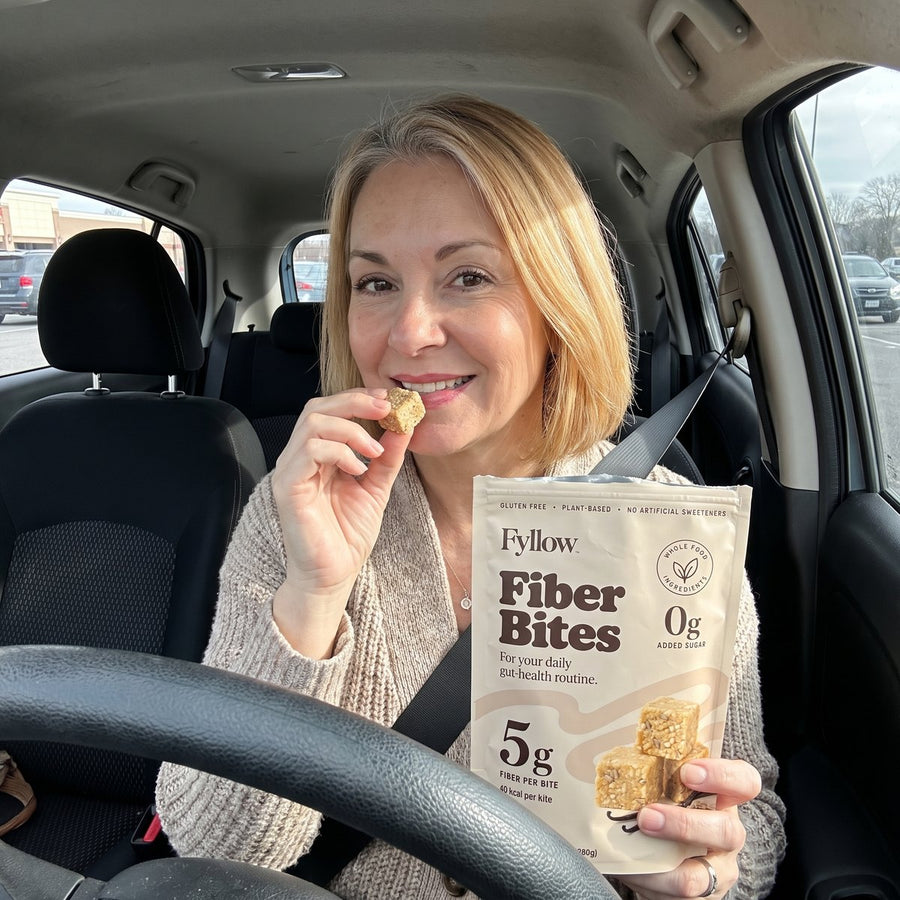 Woman grabbing a Fiber Bite in her car on a busy day