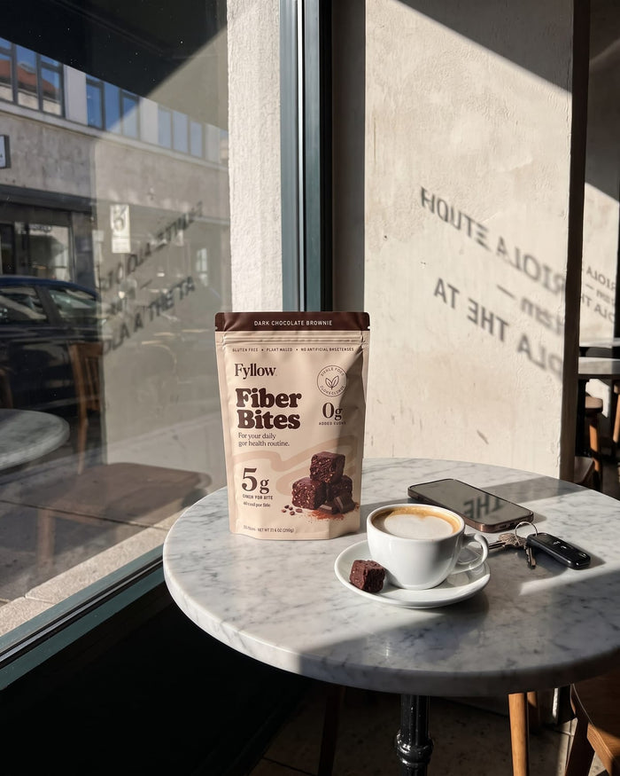 Dark Chocolate Brownie pouch on a cafe table by the window