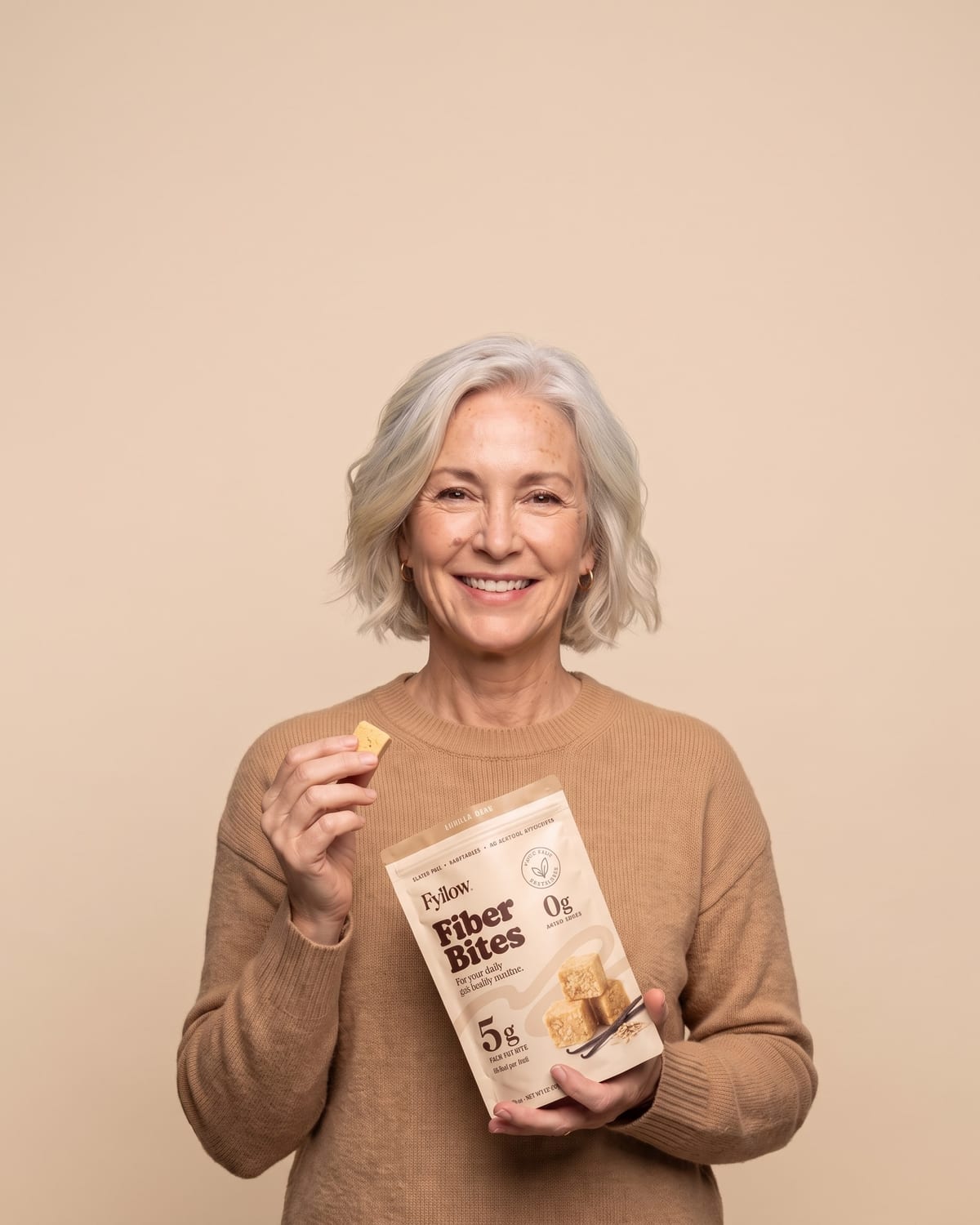 Woman in her fifties holding a Vanilla Bean pouch
